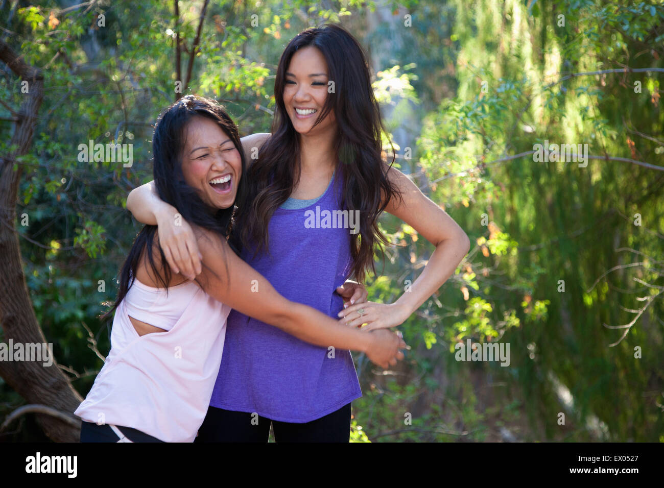 Two mid adult women fooling around in rural setting Stock Photo