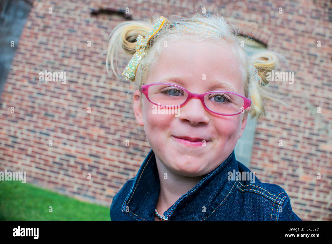 Portrait of young girl wearing pink glasses Stock Photo