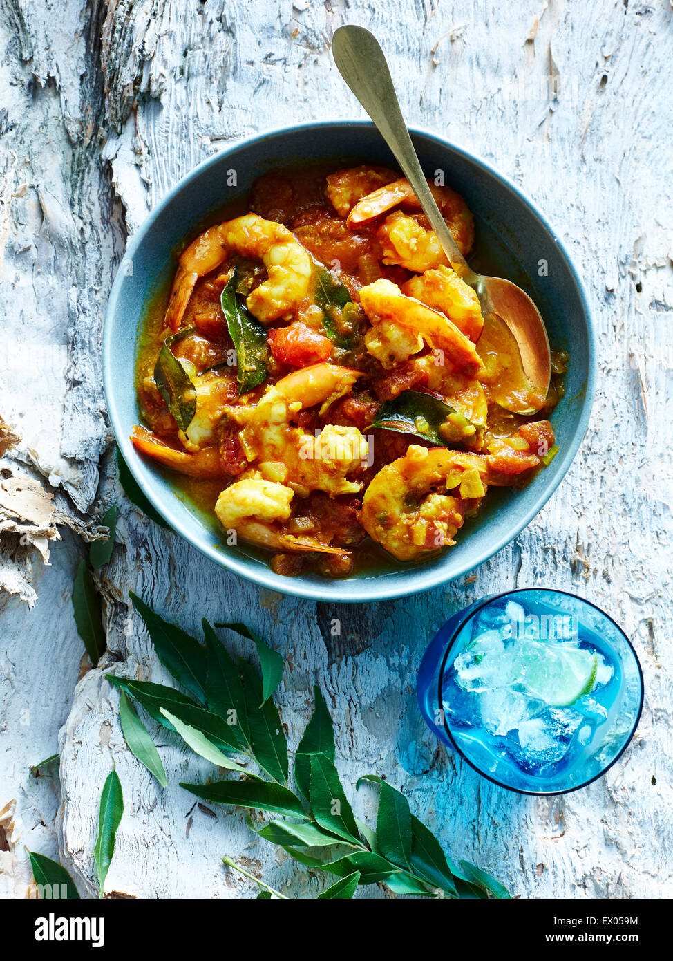 Still life with bowl of Mauritian Creole king prawn curry Stock Photo