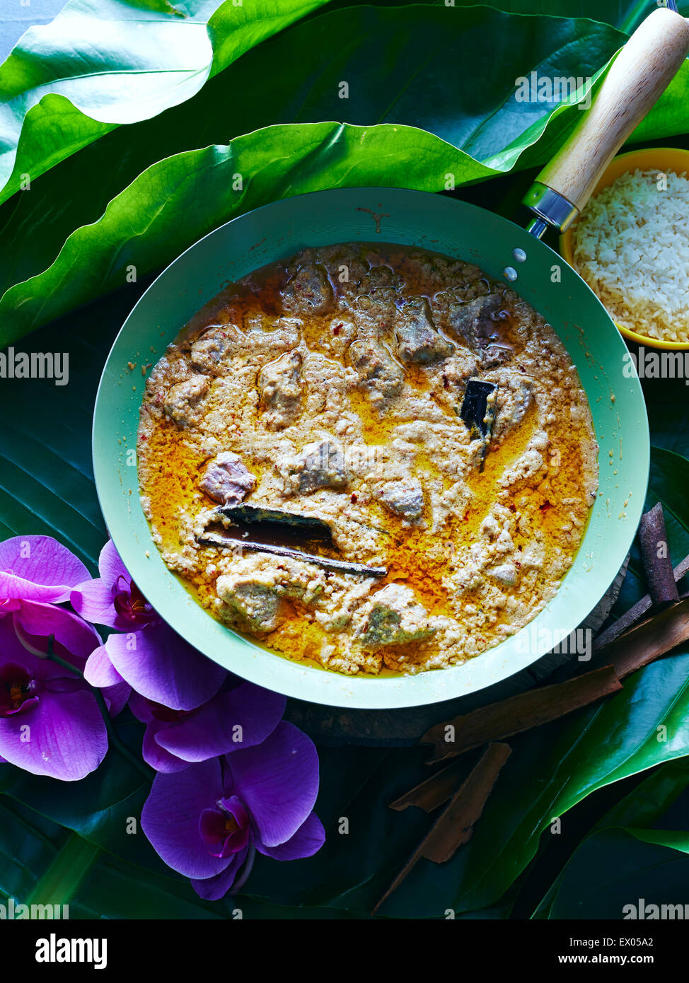 Still life with Thai massaman curry and bowl of rice Stock Photo