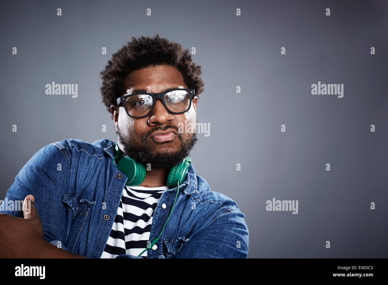 Studio portrait mid adult man posing with headphones Stock Photo