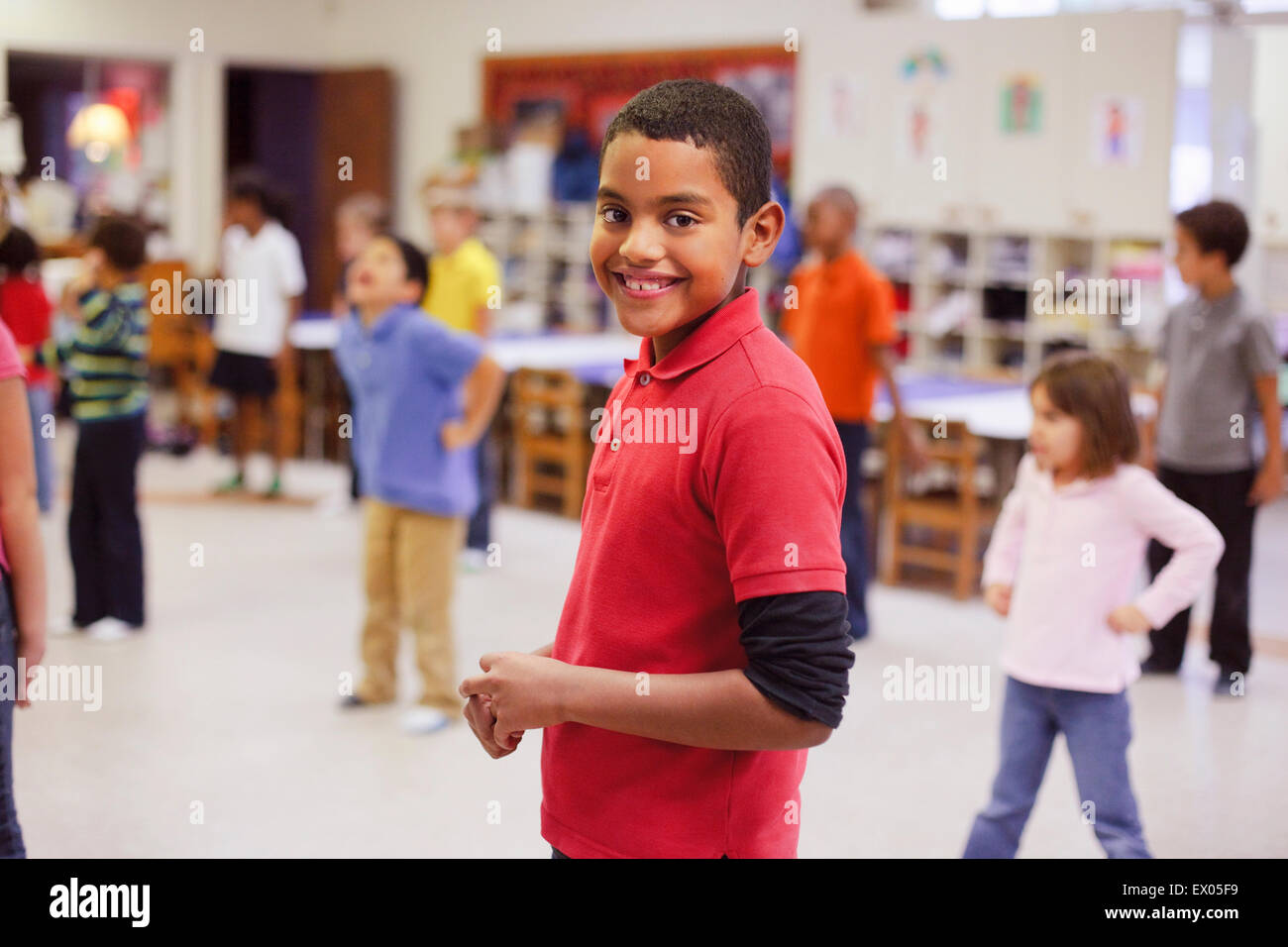 Children dancing in classroom Stock Photo