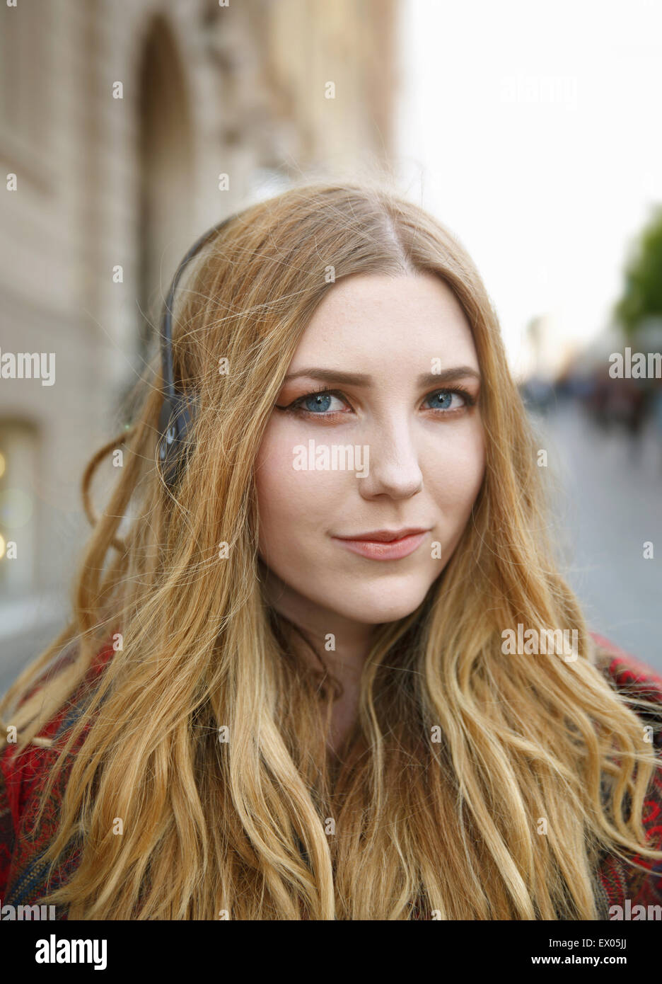 Portrait of blond young woman with headphones Stock Photo - Alamy