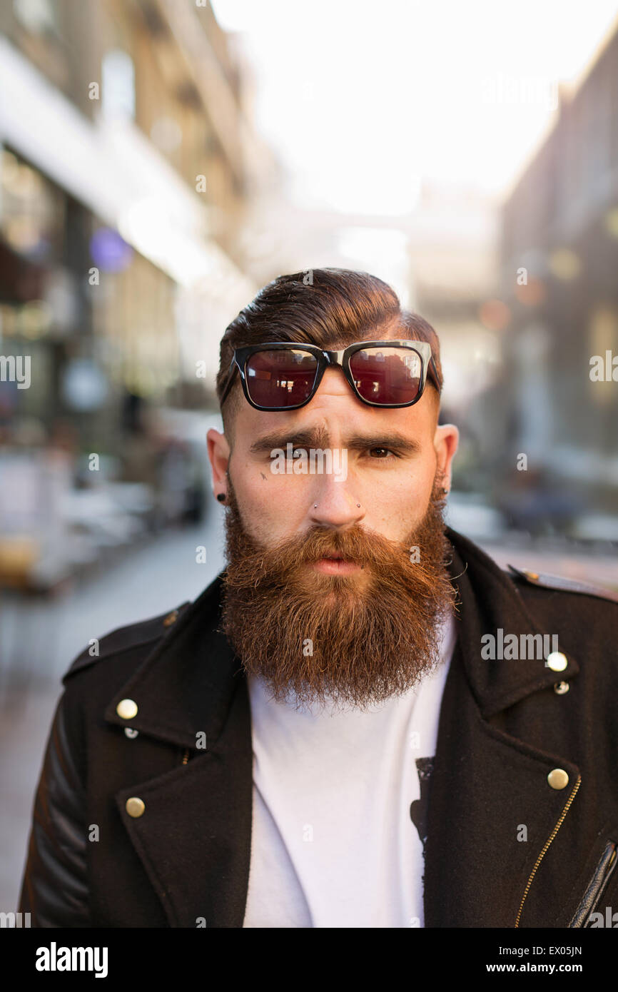 Portrait of bearded young man with sunglasses Stock Photo - Alamy
