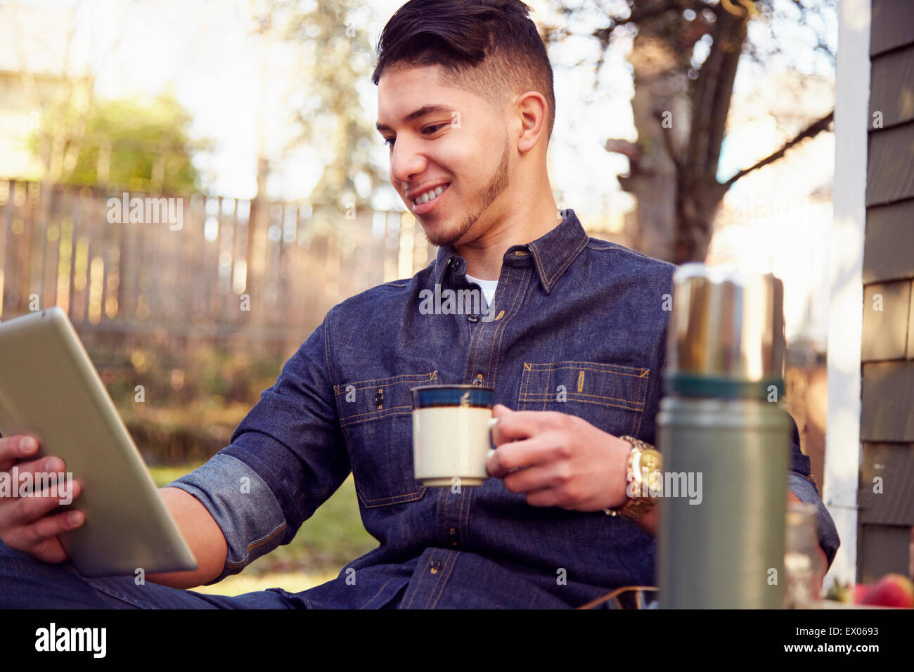 Young man using tablet with coffee Stock Photo