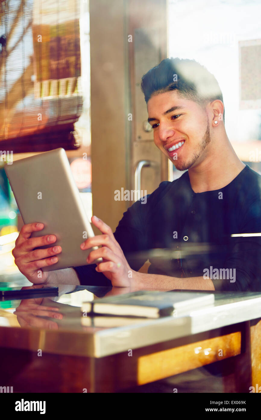 Young man in cafe using digital tablet Stock Photo