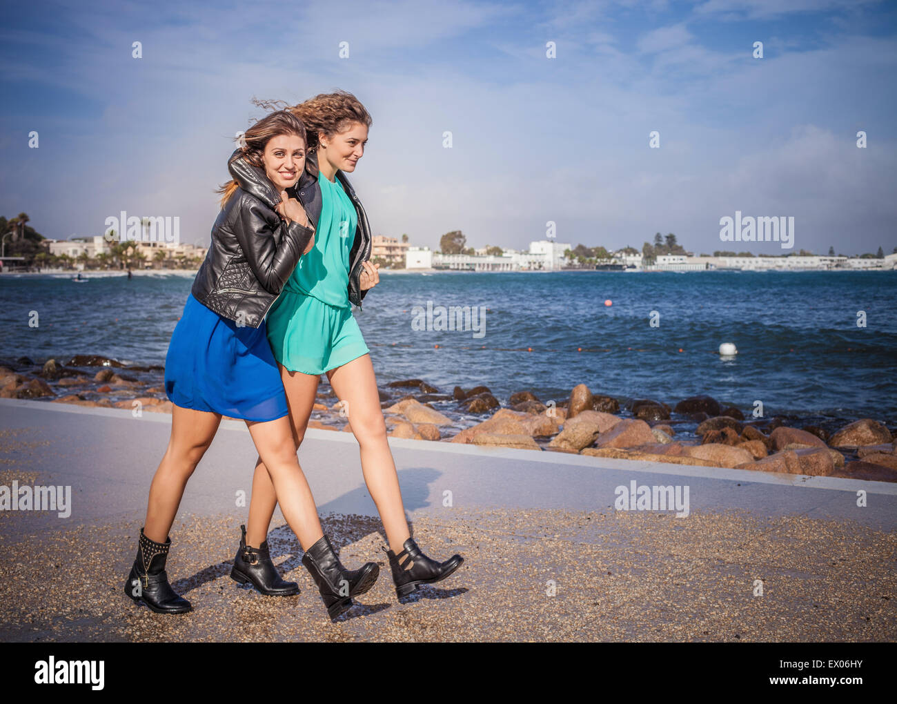 Two young women friends walking on promenade Stock Photo - Alamy