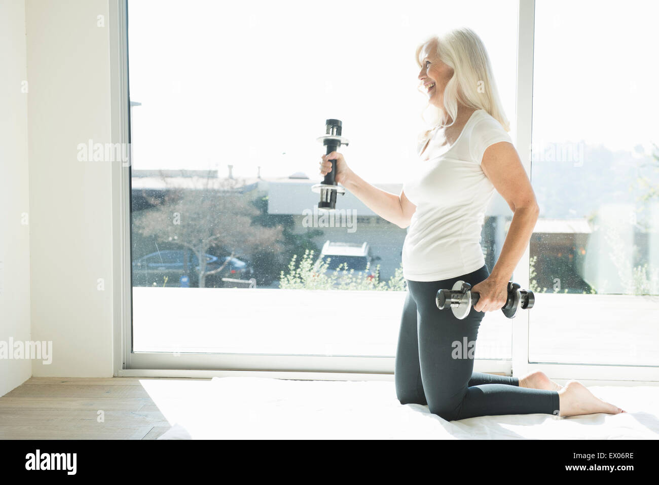 Senior woman exercising with dumbbells Stock Photo - Alamy