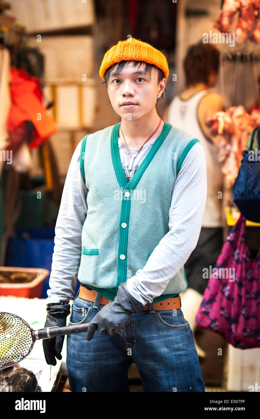 Young market worker poses at Mong Kok wet market, Kowloon Stock Photo