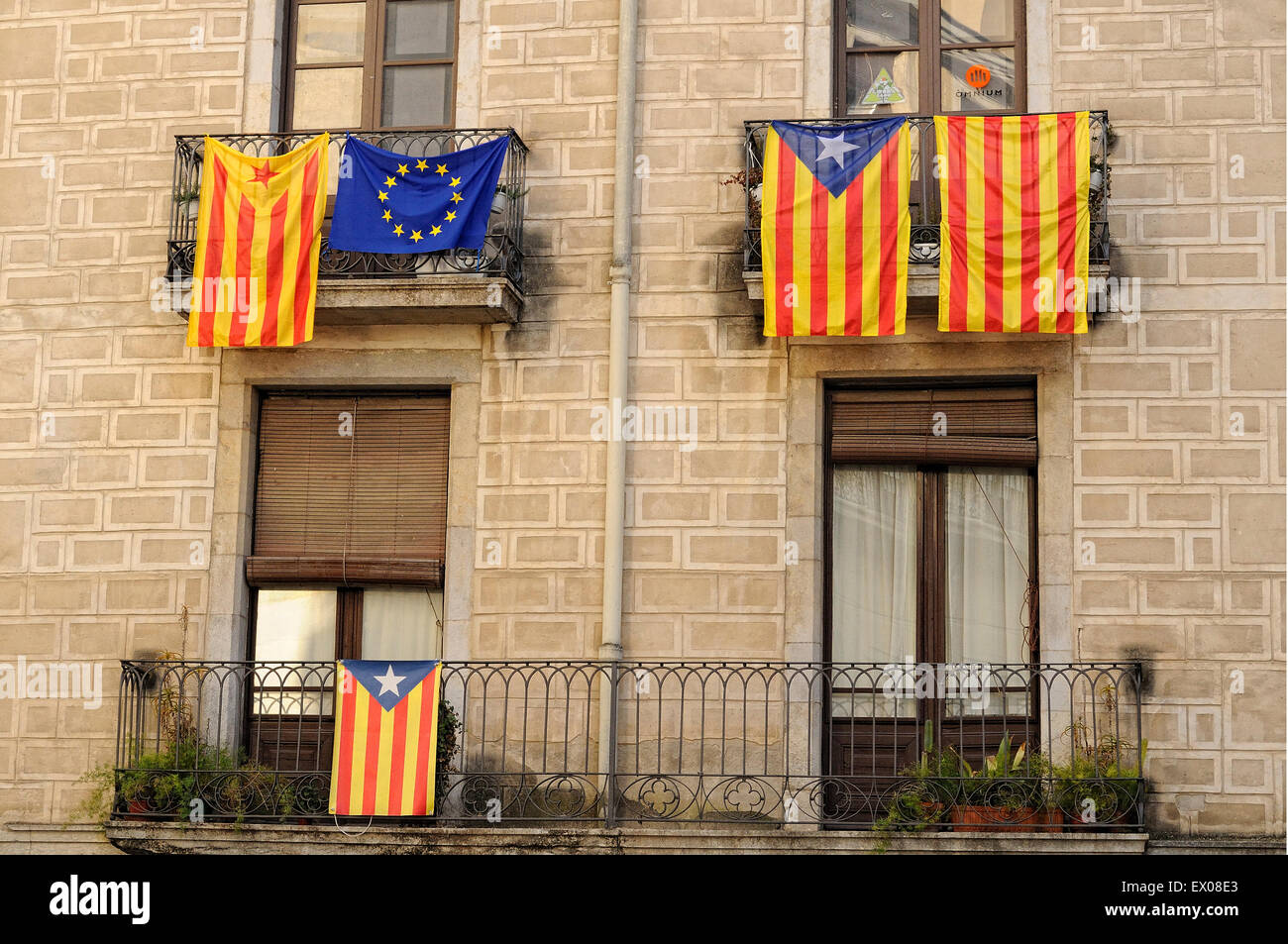 Catalonia independence flags hanging from the balconies of a facade. Girona. Catalonia. Spain. Stock Photo