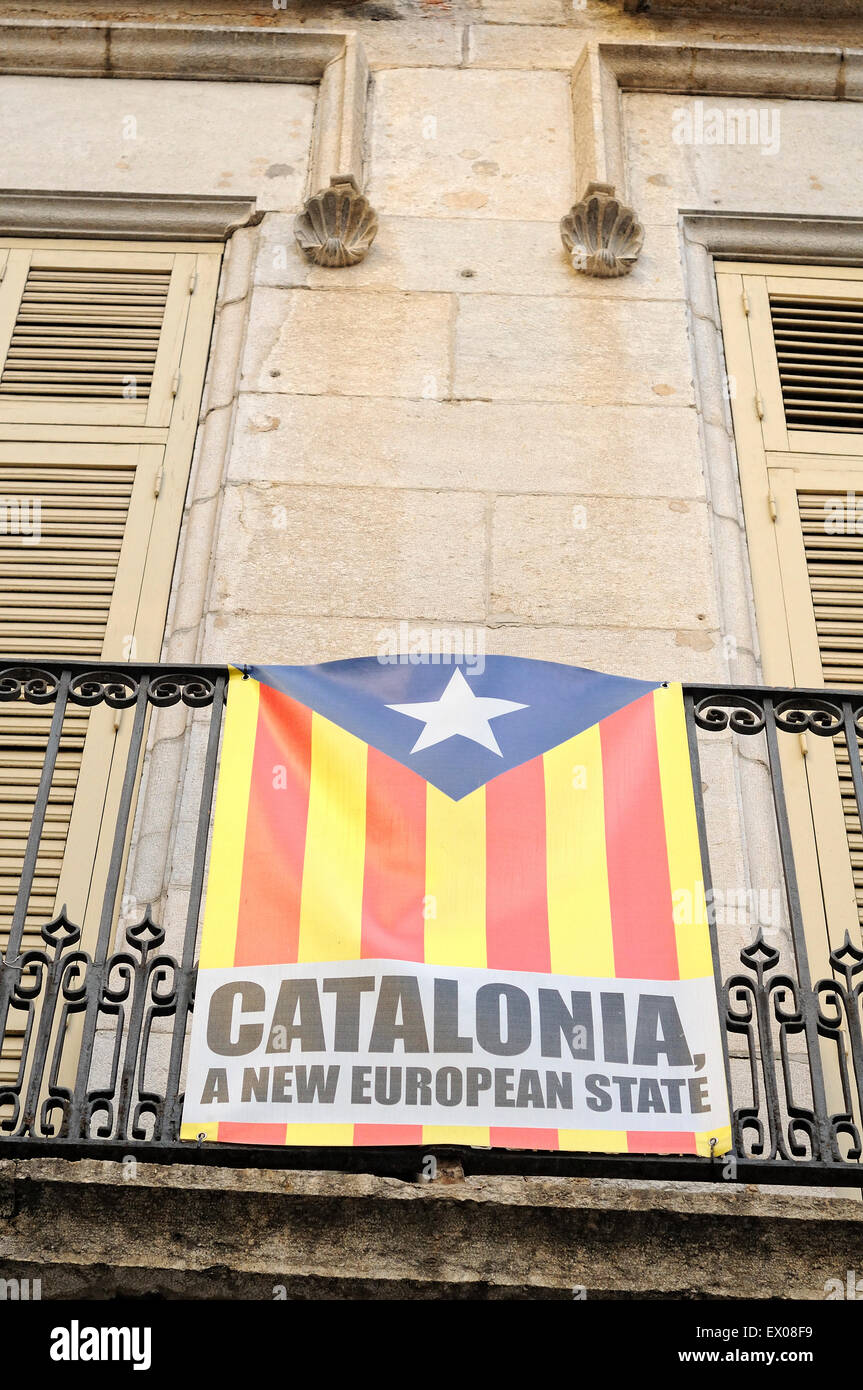 Catalonia independence flag hanging from a balcony of a facade. Girona. Catalonia. Spain. Stock Photo