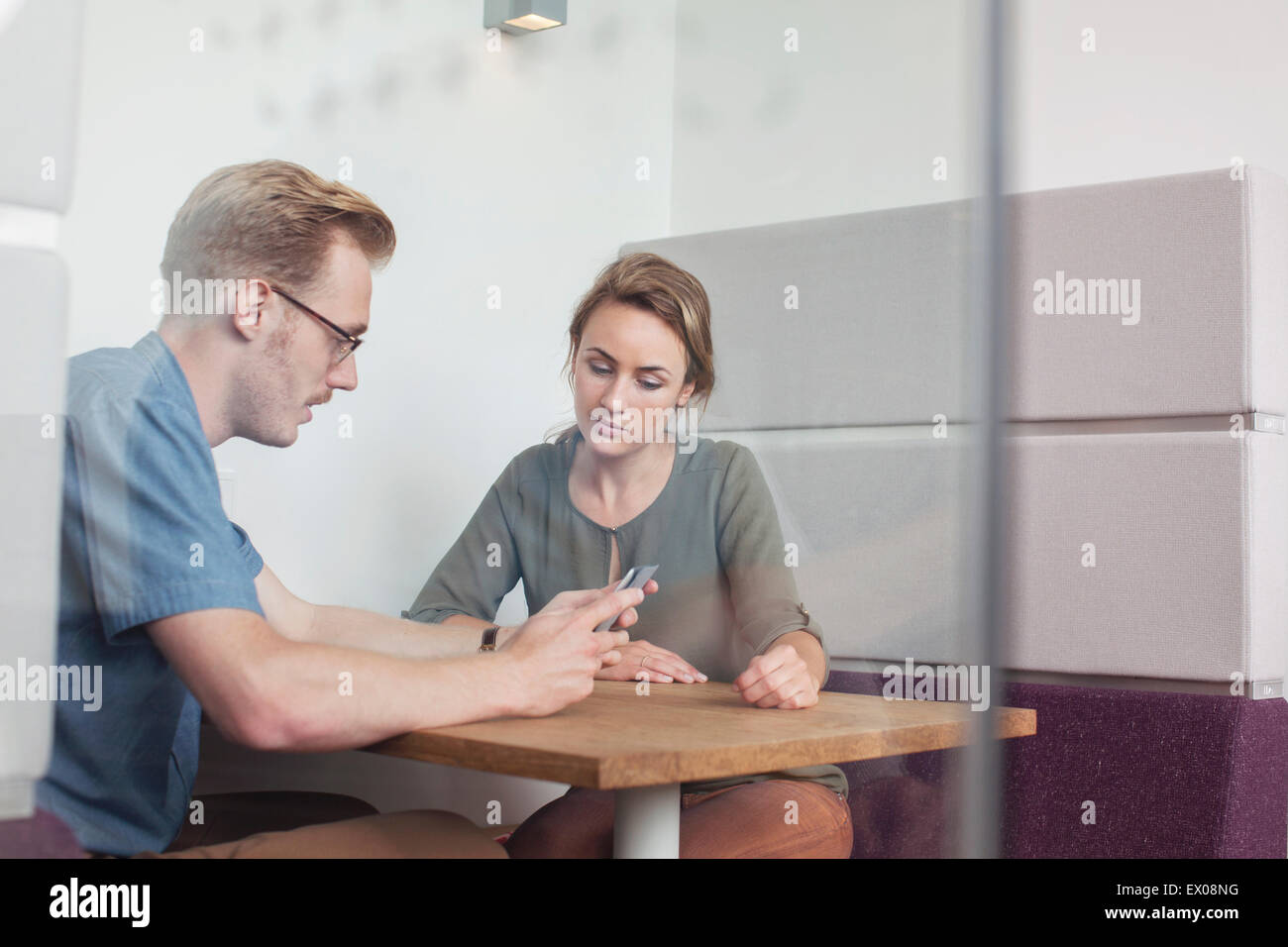 Colleagues looking at digital tablet in meeting Stock Photo