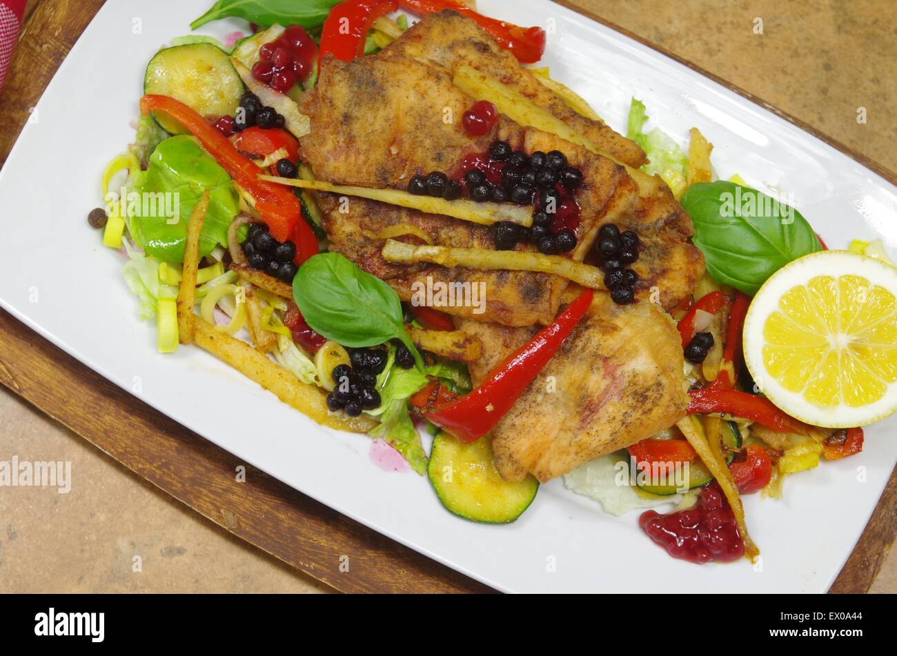 fried fish with vegetables on white plate Stock Photo Alamy