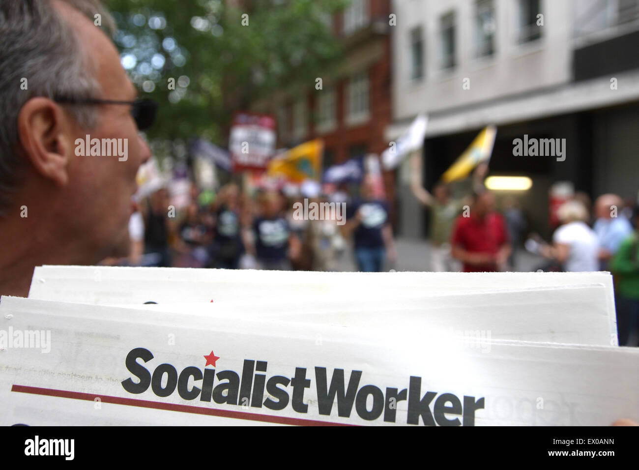 A newspaper seller with copies of Socialist Worker at an anti austerity march in London Stock Photo