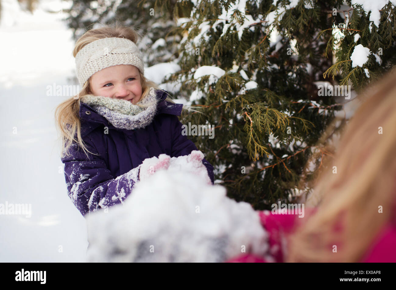 Sisters playing outside in the snow Stock Photo - Alamy