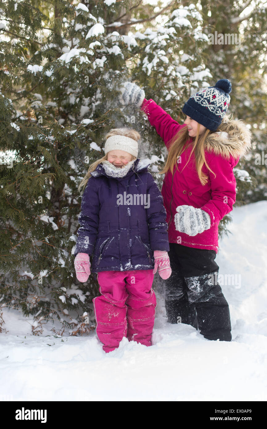 Sisters playing outside in the snow Stock Photo - Alamy