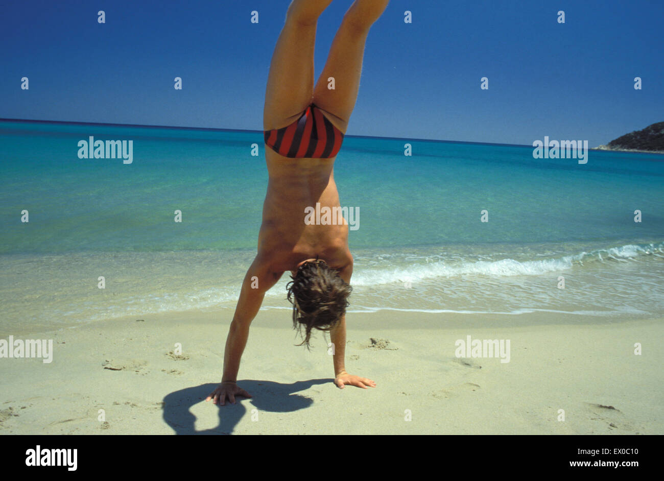 ITA, Italy, Sardinia, handstand at the beach of South Sardinia.  ITA, Italien, Sardinien, Handstand am Strand von Sued-Sardinien Stock Photo