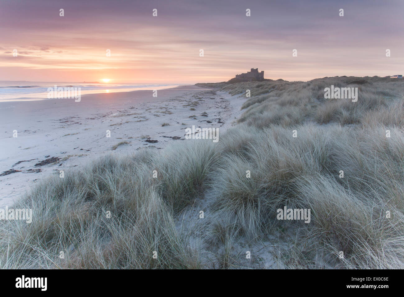 Bamburgh Castle shot from Bamburgh Beach at sunrise, Bamburgh, Northumberland, UK Stock Photo
