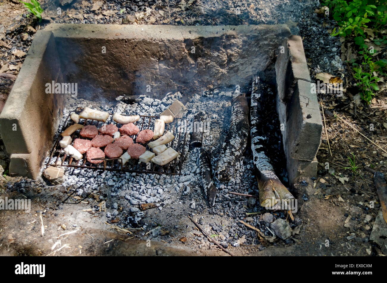 Steaks cooking over hot coals from open fire Stock Photo Alamy