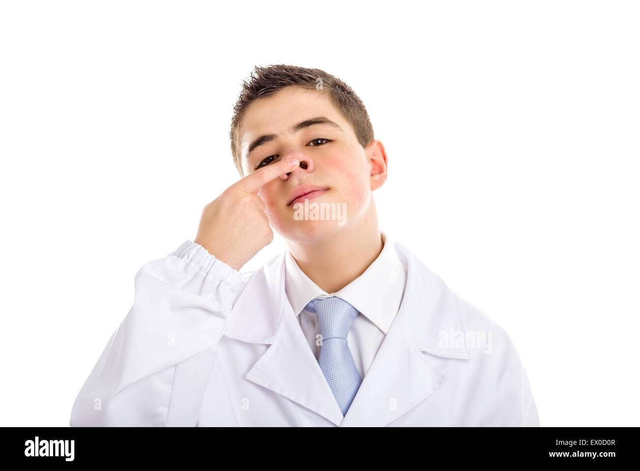child dressed as a doctor in light blue tie and white coat helps to feel medicine more friendly: he is touching and pushing up his nose. His acne skin has ben retouchedand softened Stock Photo