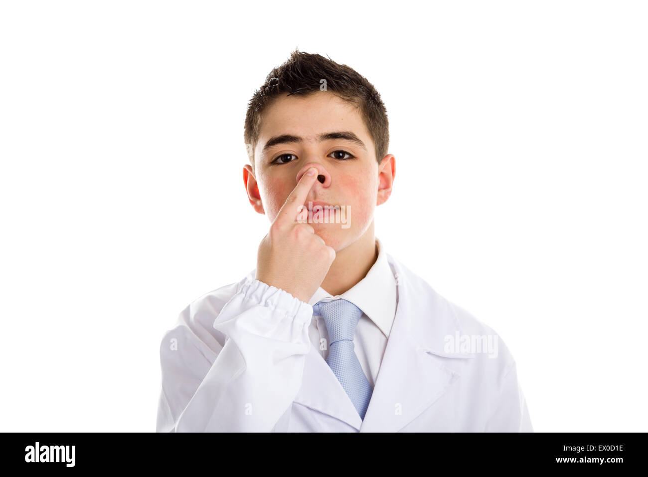 child dressed as a doctor in light blue tie and white coat helps to feel medicine more friendly: he is touching and pushing up his nose. His acne skin has not ben retouched Stock Photo
