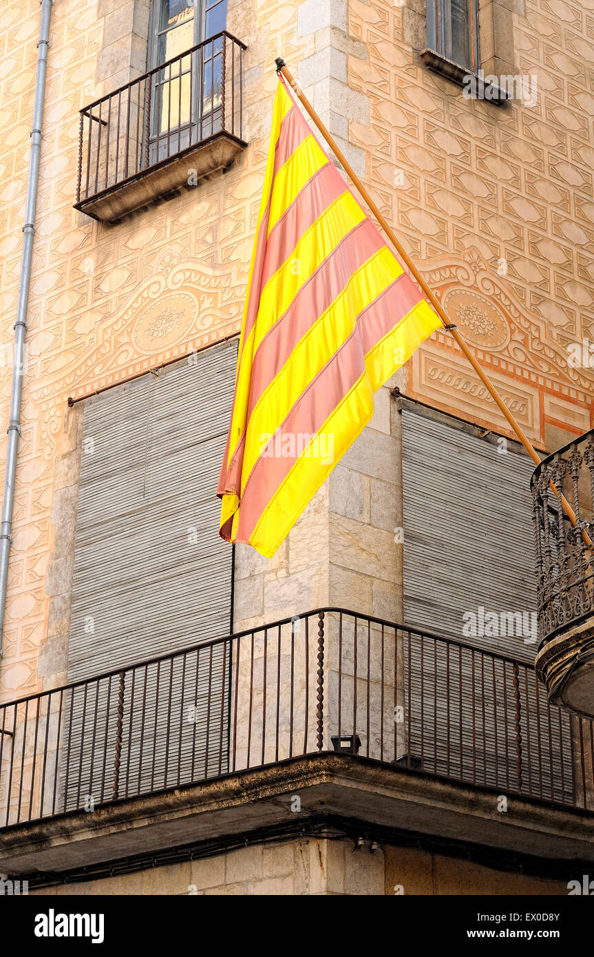 Catalonia independence flag hanging from a balcony of a facade. Girona. Catalonia. Spain. Stock Photo