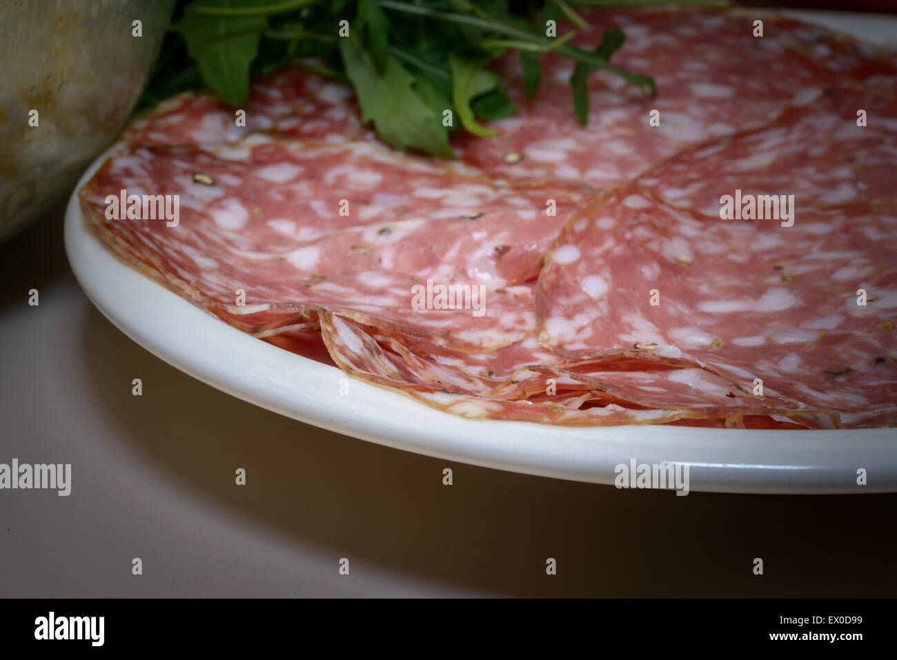 A Tipical Tuscany italian salami called finocchiona with rucola, tomato