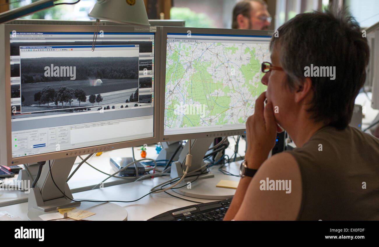 Lueneburg, Germany. 3rd July, 2015. Specially-trained forrester Betti Buchholtz sits in front of monitors and checks pictures from 20 forest fire observation cameras in 6 districts, in Lueneburg, Germany, 3 July 2015. PHOTO: PHILIPP SCHULZE/DPA/Alamy Live News Stock Photo
