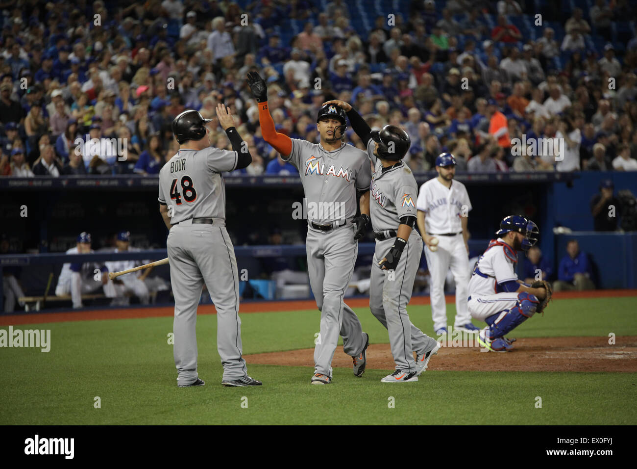 Miami Marlins players congratulate each other on scoring a run Stock Photo