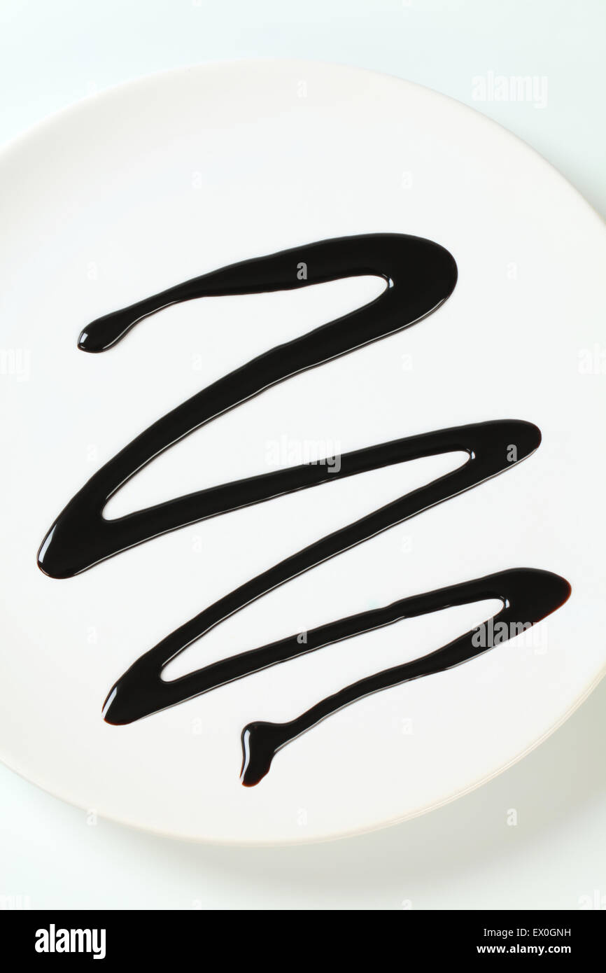 Chocolate syrup drip on plate Stock Photo