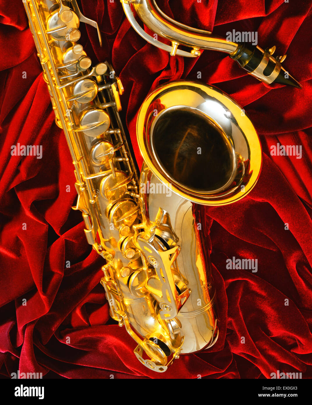 Golden saxophone on a red velvet Stock Photo