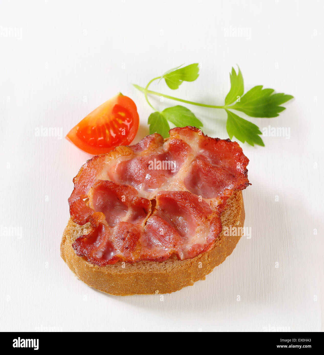 Pan-fried slice of pork meat on a piece of bread Stock Photo