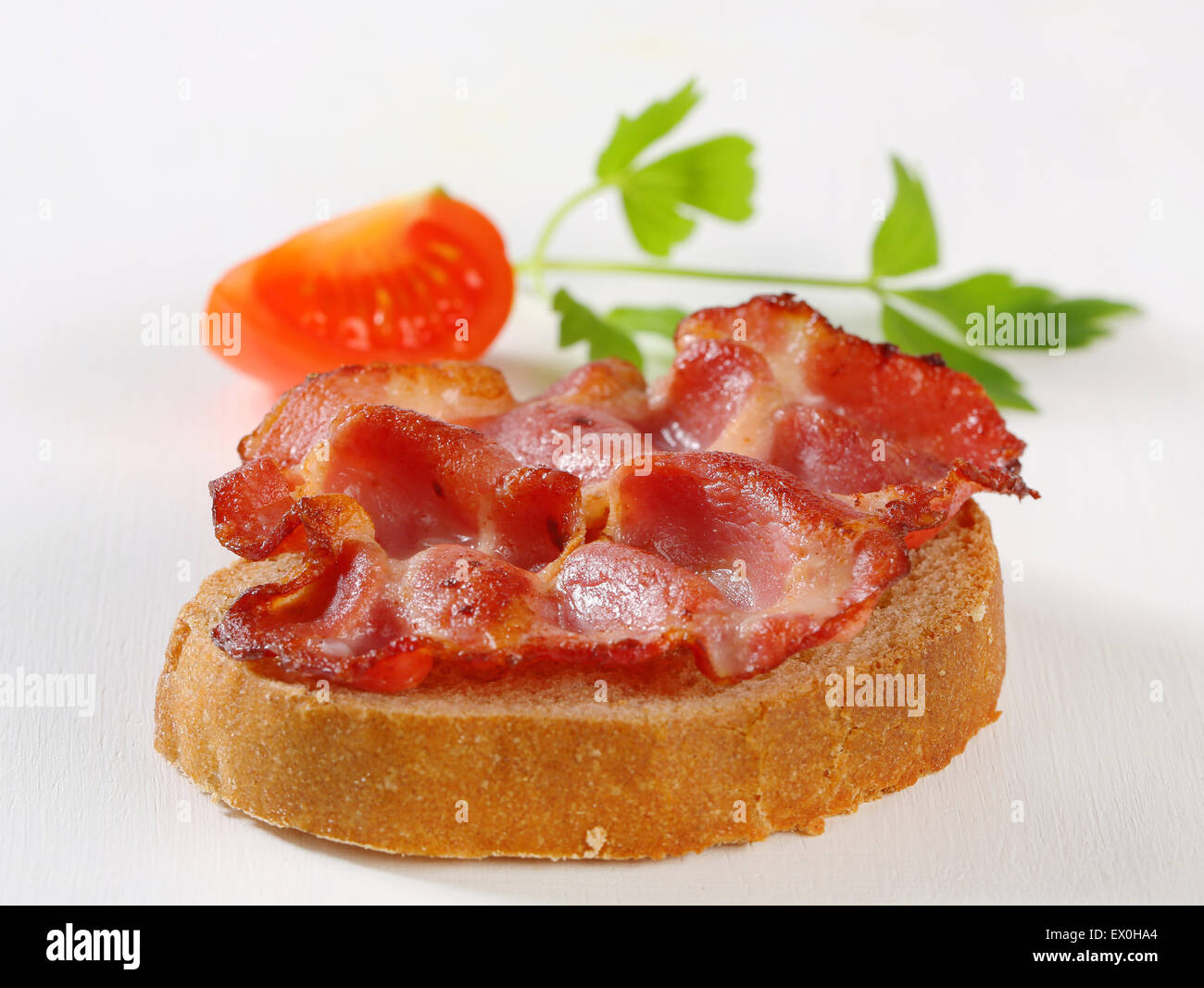 Pan-fried slice of pork meat on a piece of bread Stock Photo