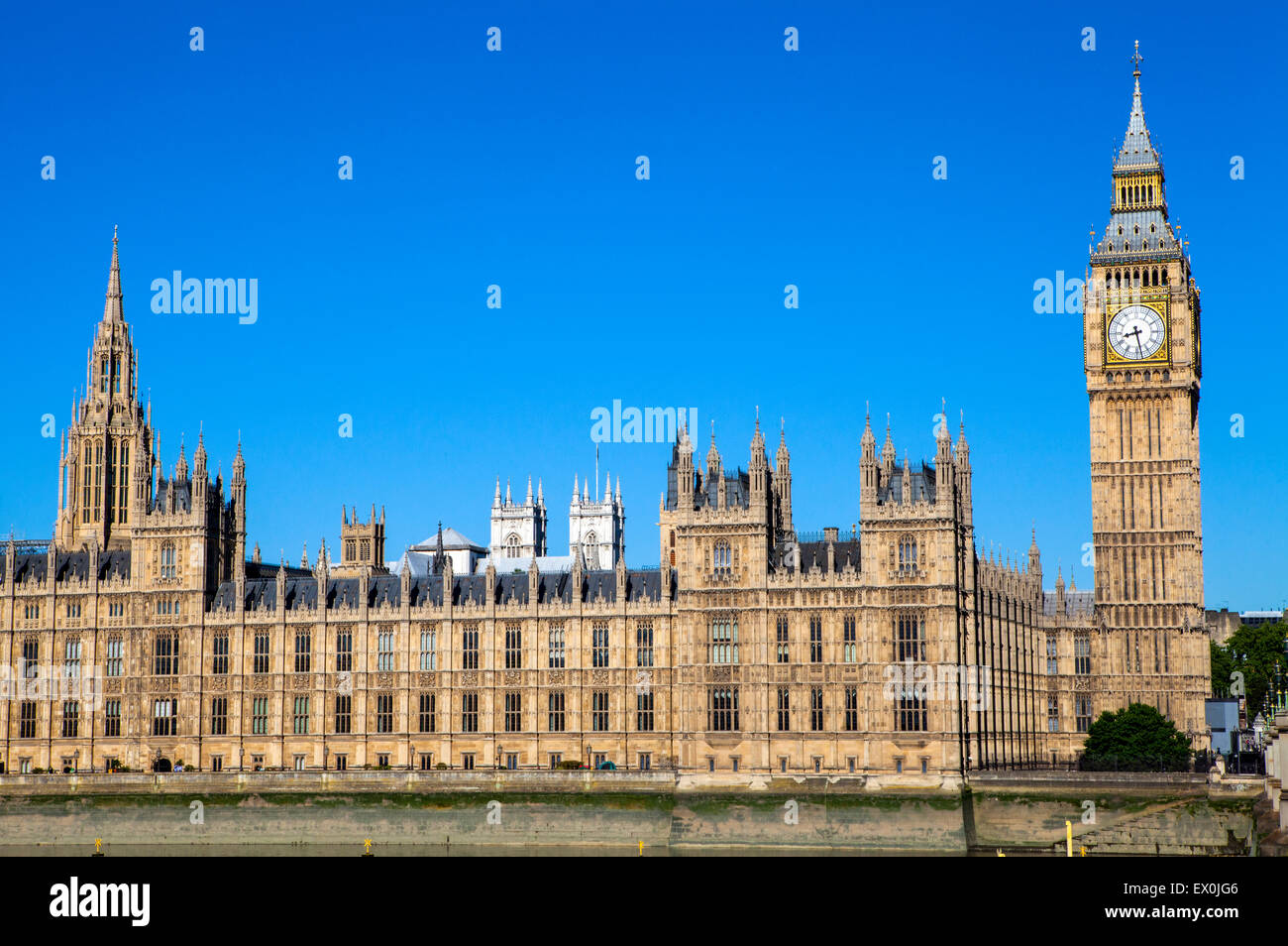 A view of the magnificent Palace of Westminster in London.  The towers of Westminster Abbey can be seen in the distance. Stock Photo