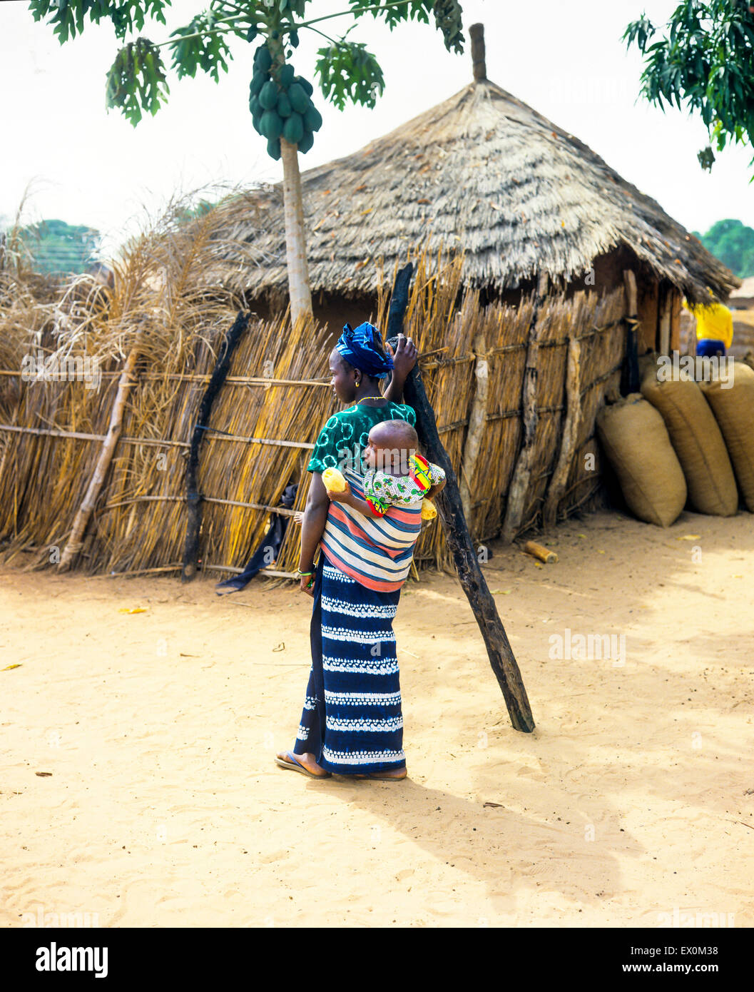 Young Gambian woman carrying baby on her back, Juffureh village, Gambia, West Africa Stock Photo