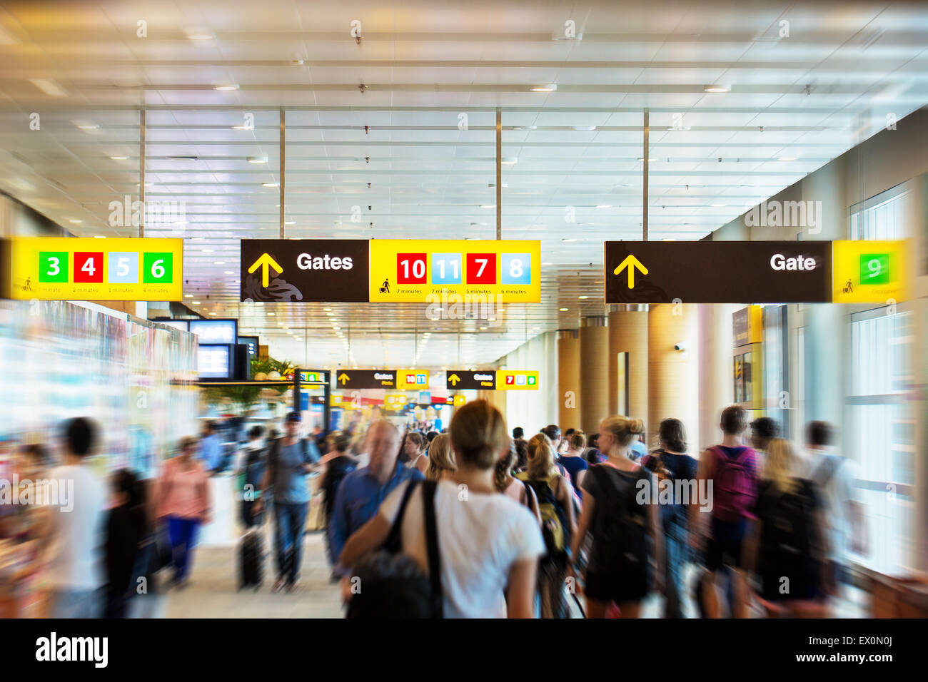 Airport terminal with people hurrieng to the gates Stock Photo