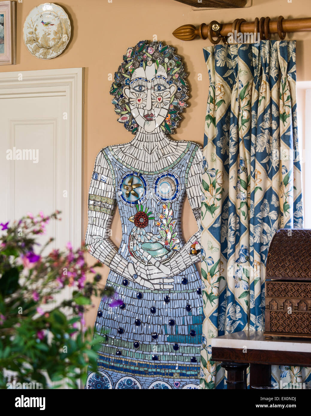 Mosaic by Cleo Mussi on wall next to Jane Churchil 'Tulip Squares' curtains Stock Photo