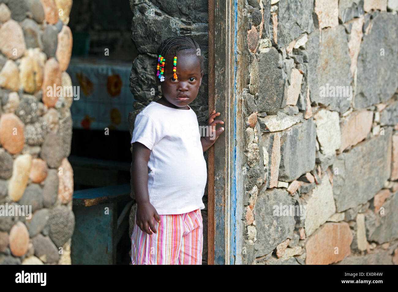 Creole girl with braided hair decorated with colourful beads in the village Rebelados on the island Santiago, Cape Verde, Africa Stock Photo