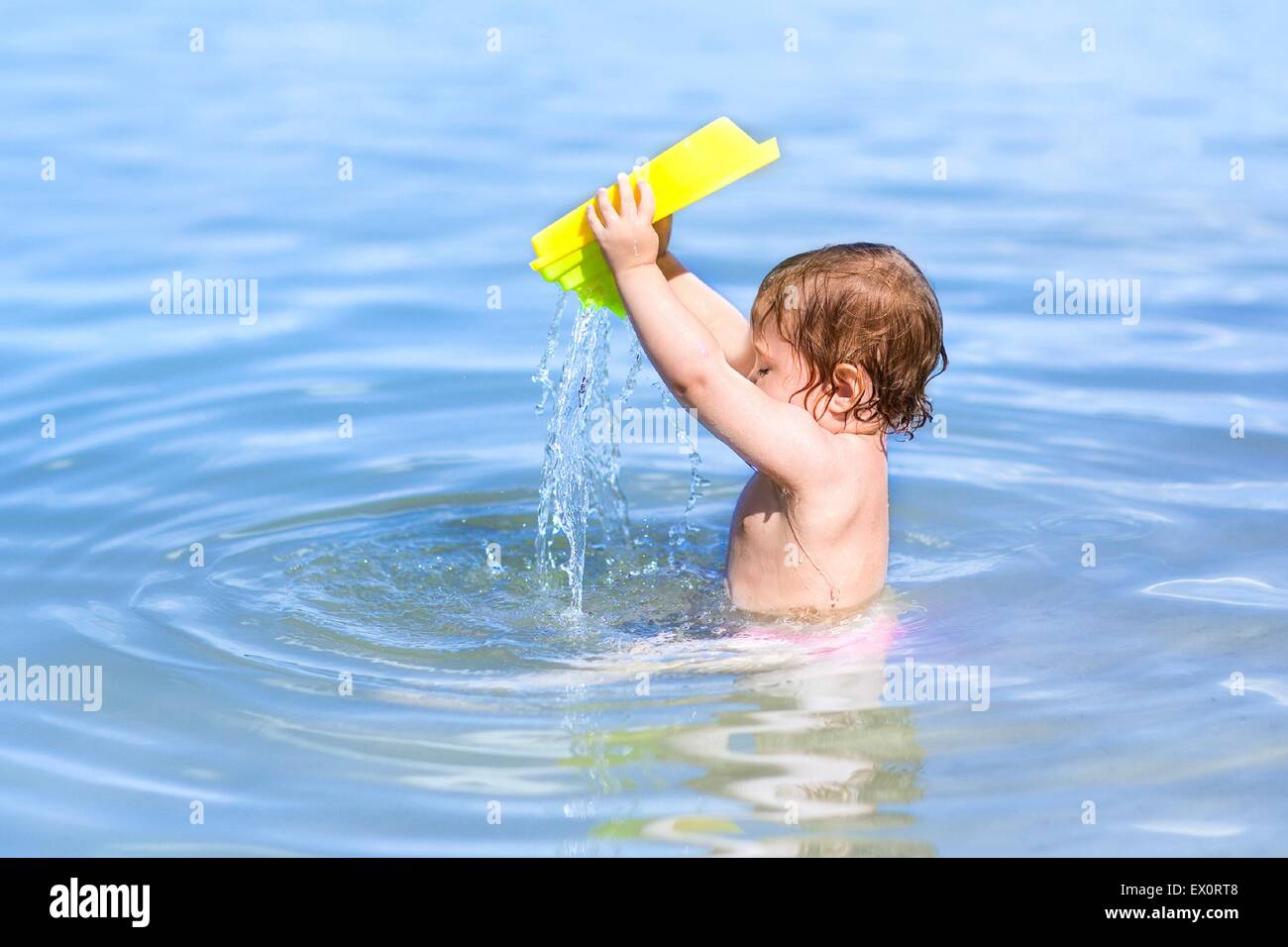 Little baby playing in the water on a beautiful beach Stock Photo Alamy