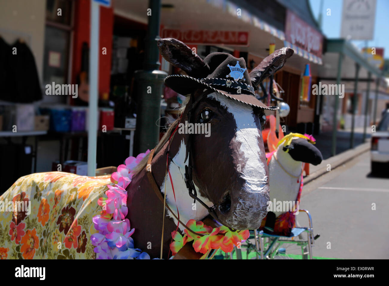 Funny horse made of paper mache in front of second hand shop Stock Photo