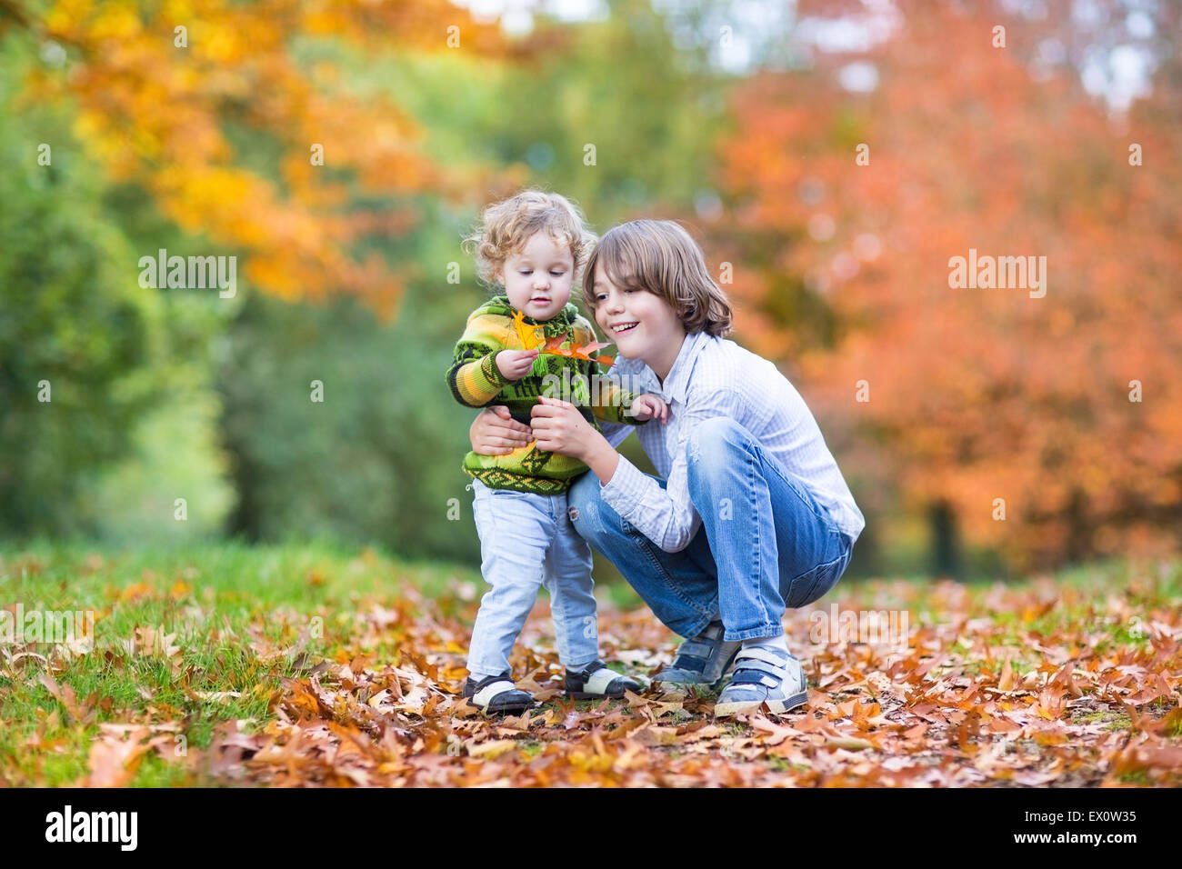 Sweet little toddler girl and her cute brother playing together in a ...