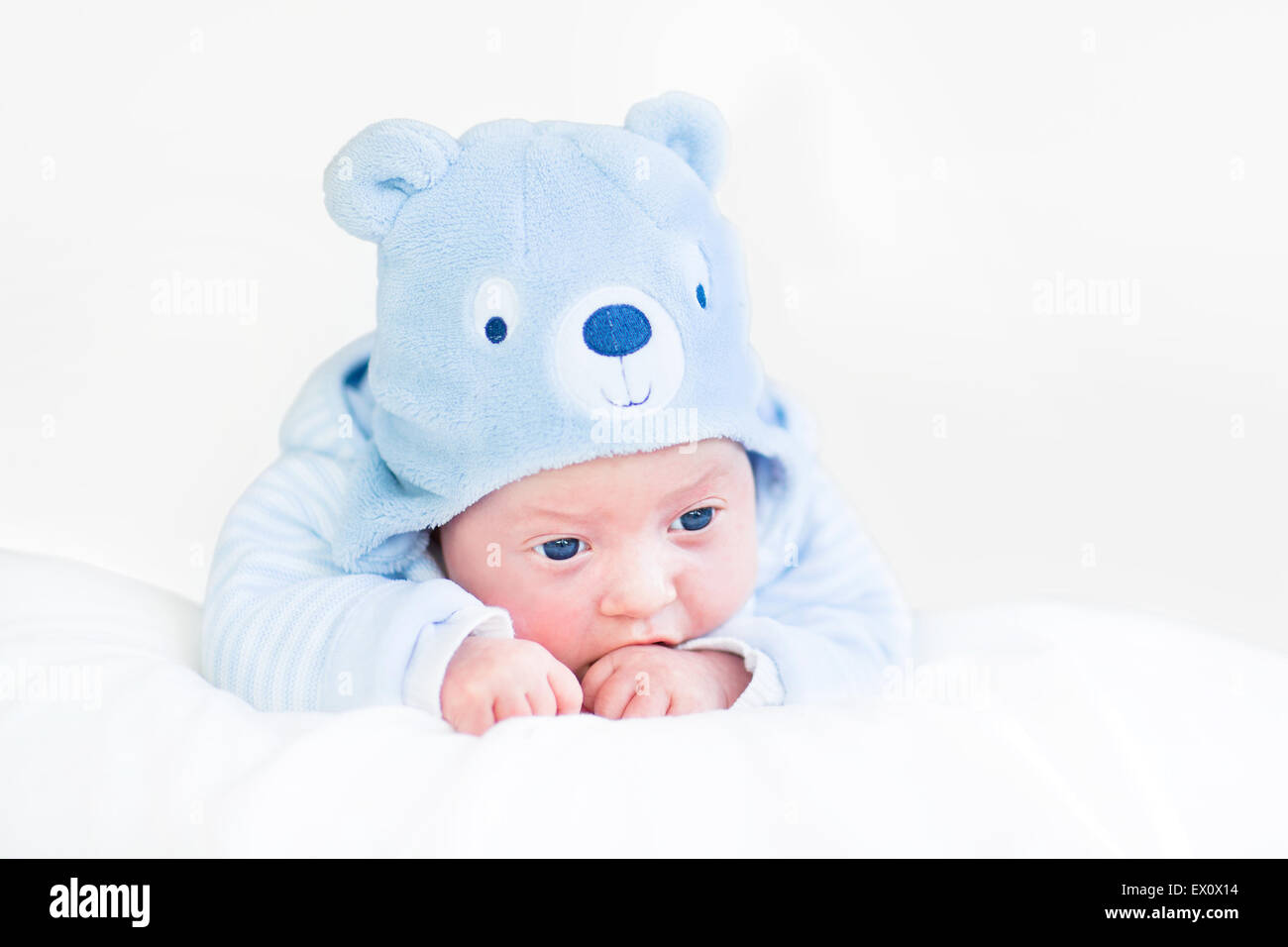 Adorable newborn baby boy in a blue teddy bear hat Stock Photo - Alamy