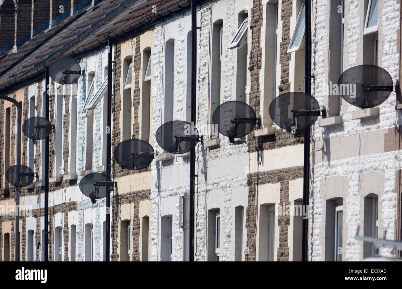 TV satellite dishes on exteriors of terraced houses Cardiff Wales UK Stock Photo