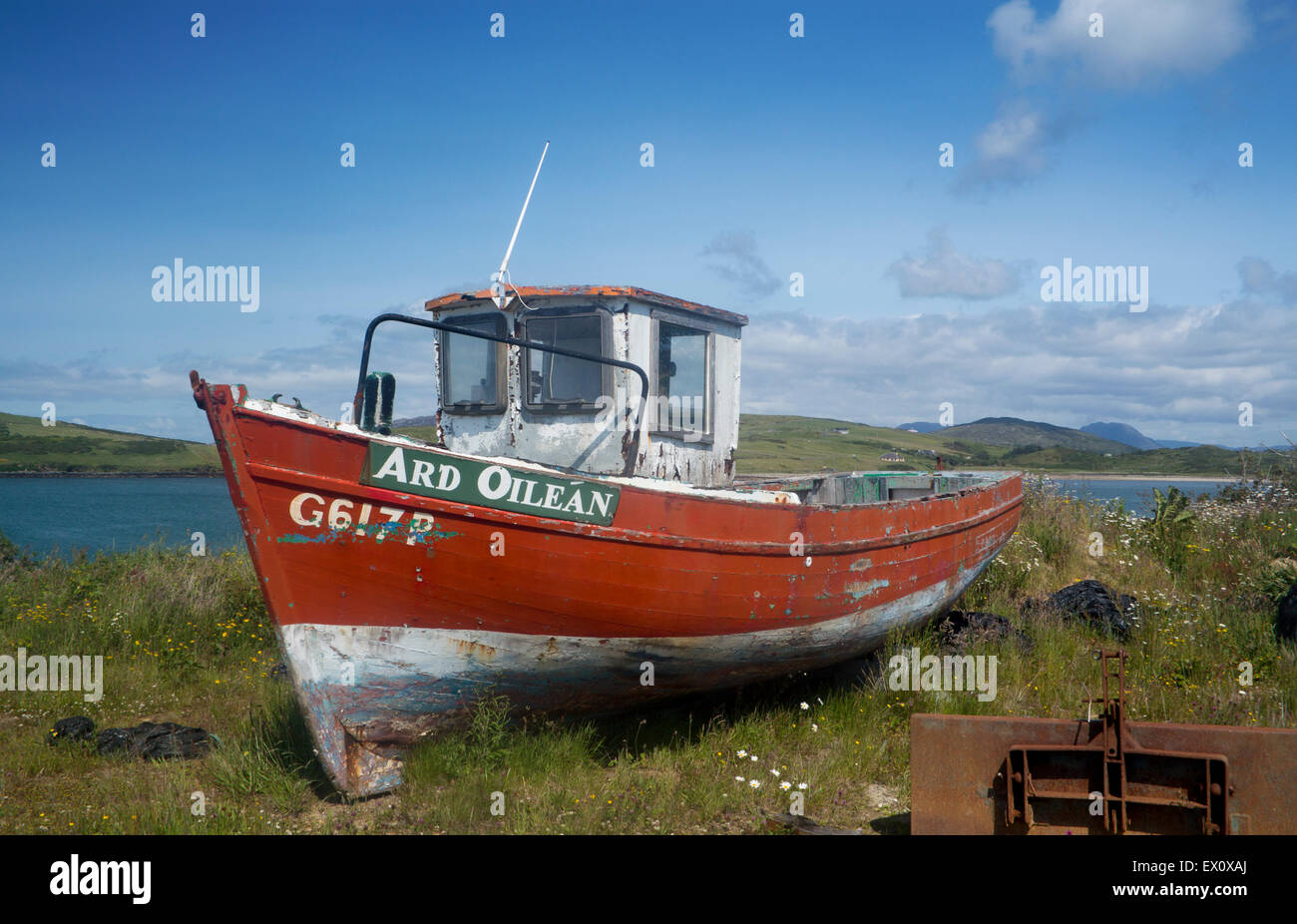 Old red fishing boat on shore with Twelve Bens mountains in background Cleggan Connemara County Galway Eire Republic of Ireland Stock Photo
