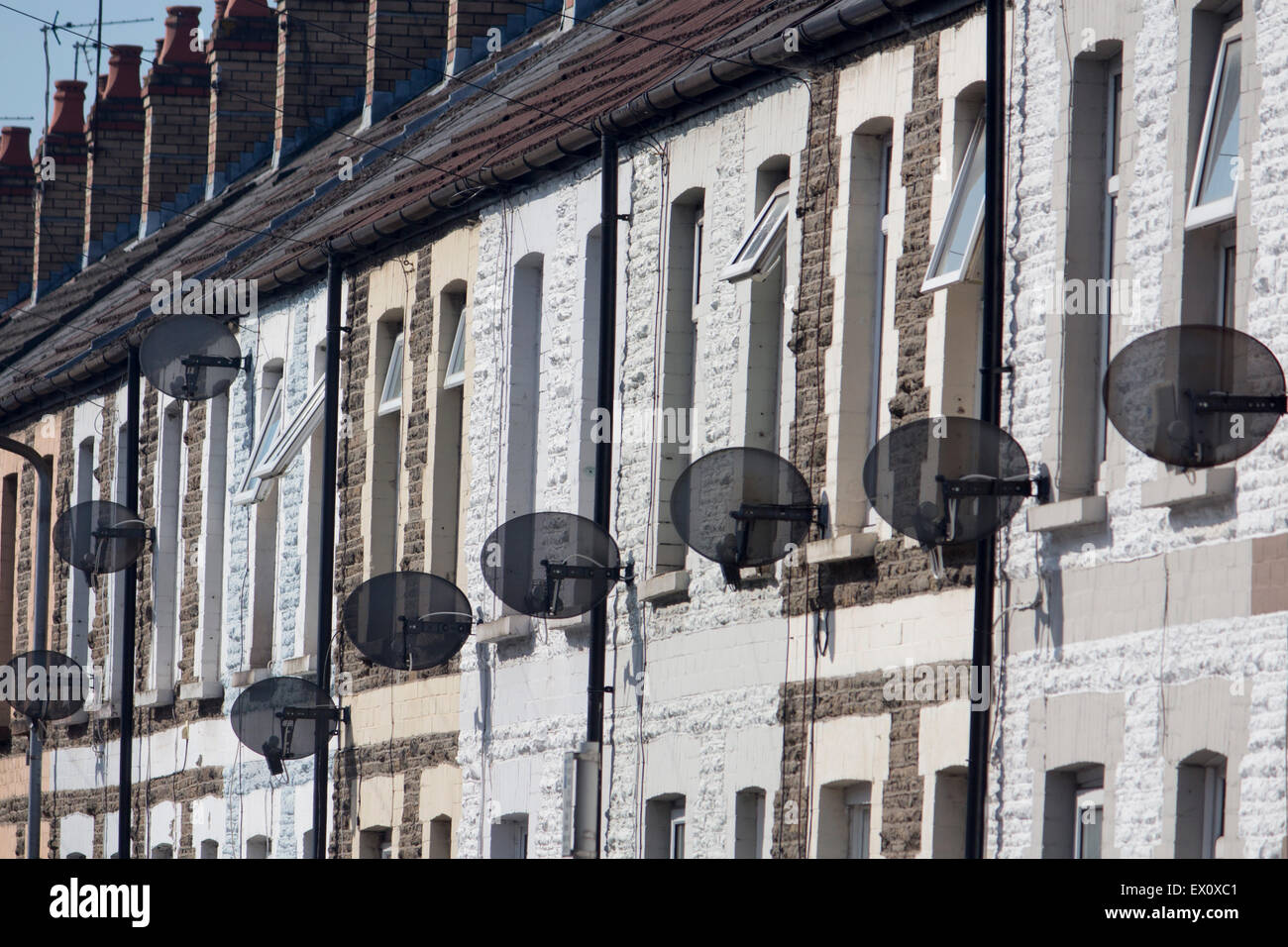 TV satellite dishes on fronts of terraced houses Cardiff Wales UK Stock Photo