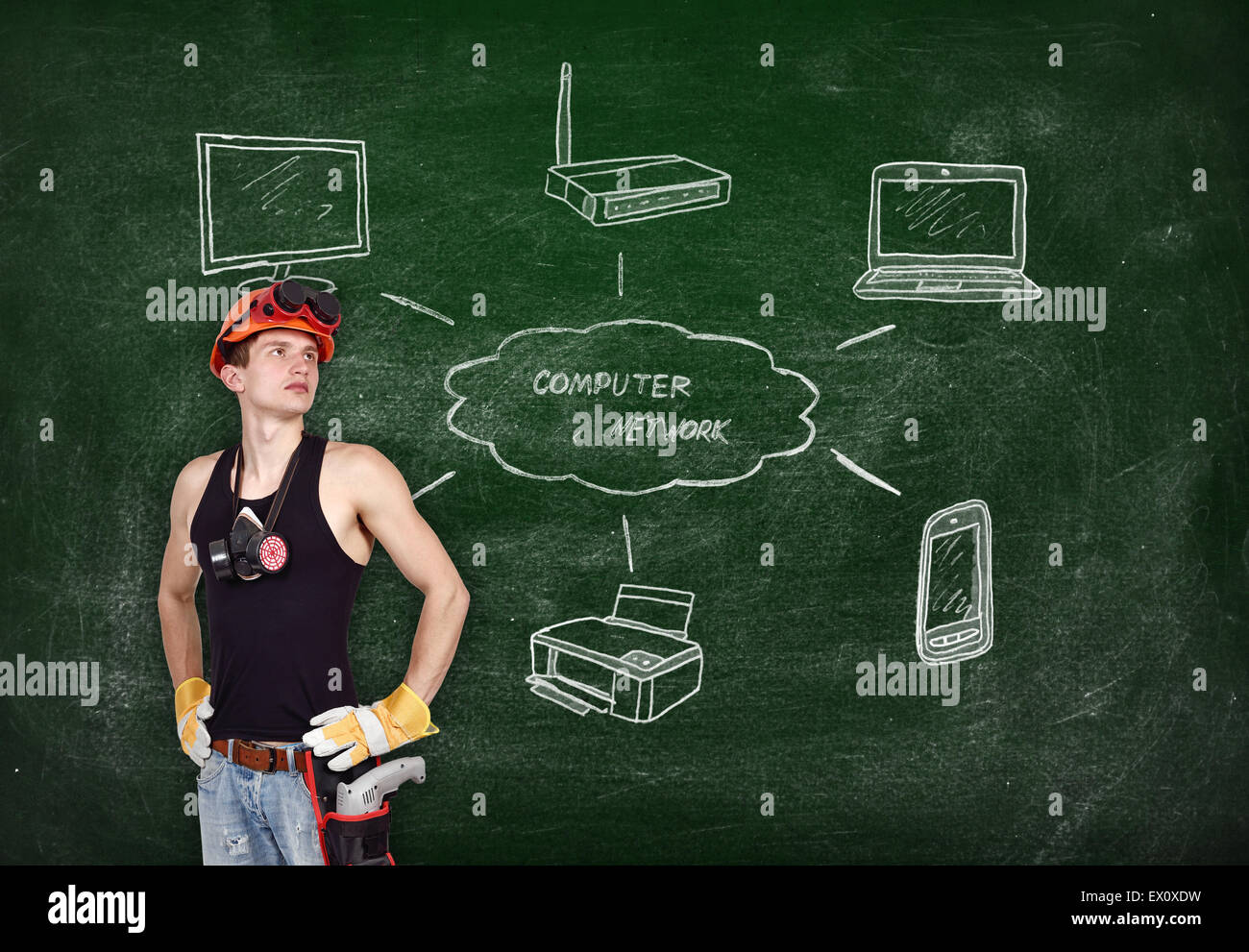 repairman with drill and drawing computer network on blackboard Stock Photo