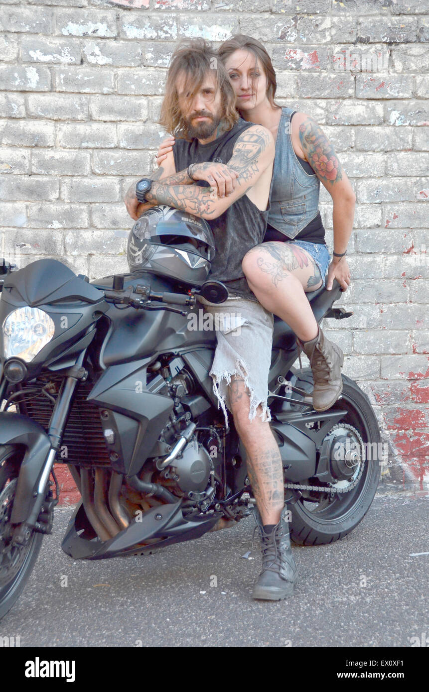 Wild looking tattooed couple on a motor bike Stock Photo