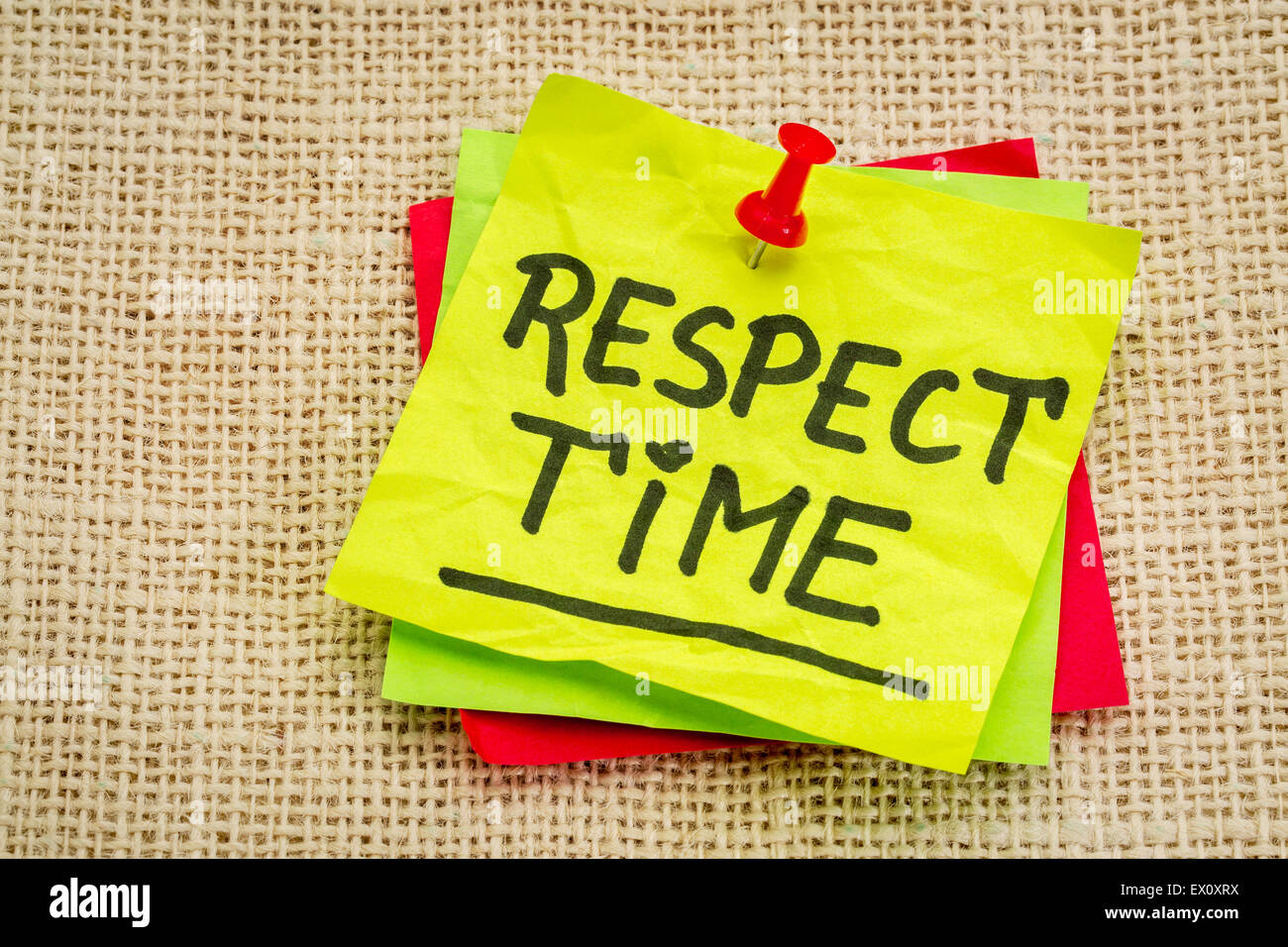 respect time reminder - handwriting on a sticky note against burlap canvas Stock Photo