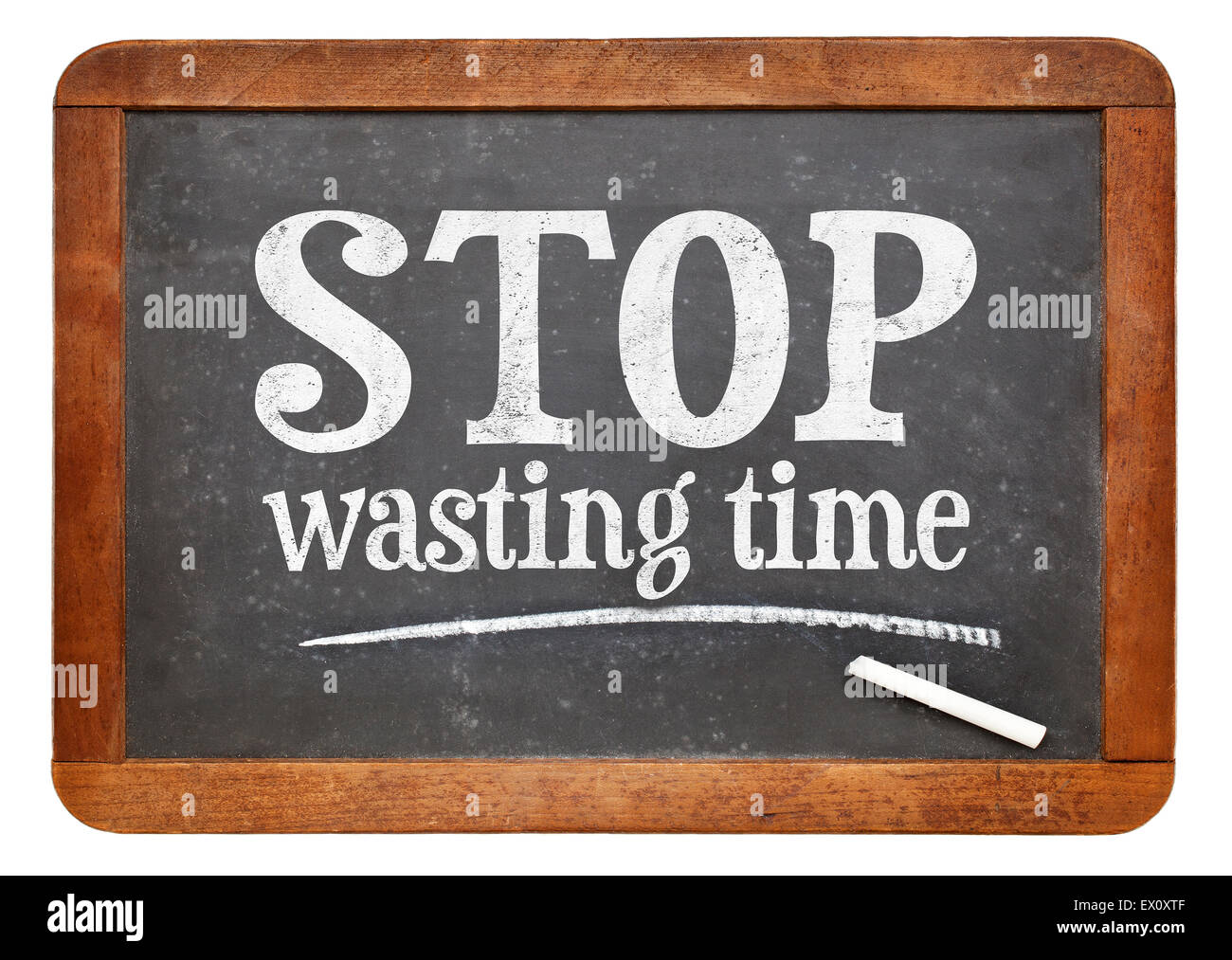 Stop wasting time sign - white chalk text on a vintage slate blackboard Stock Photo