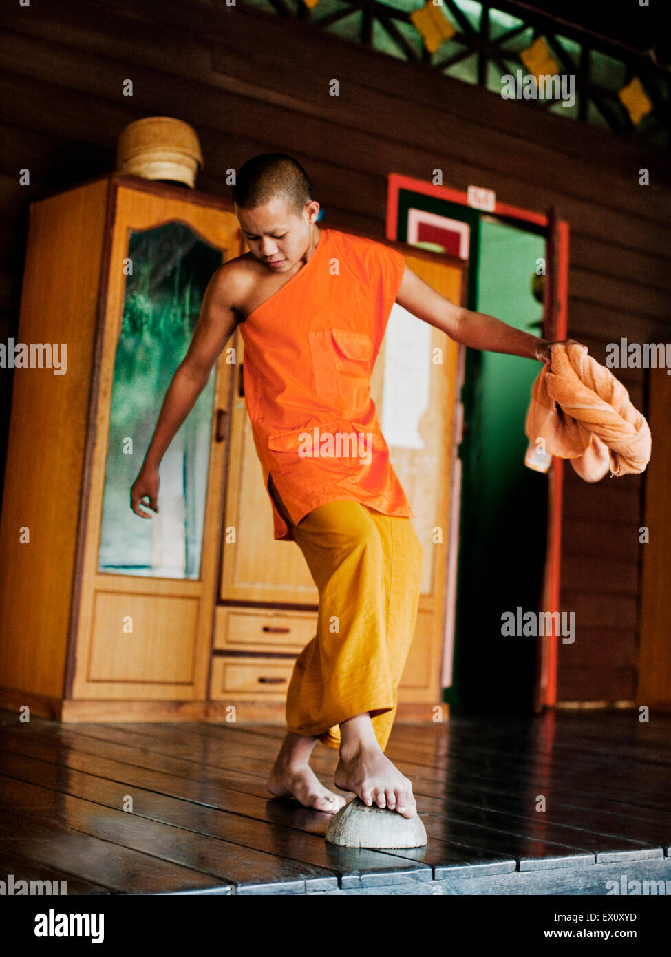 Young monks clean the floor of thier living quarters at  Wat Si Muang, Vientiane, Laos, P.D.R. Stock Photo